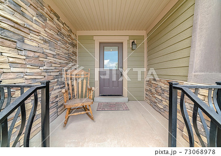 Front porch of modern house with rocking chair 73068978