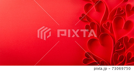 Top view of red paper hearts on red paper background with copy space. Love and Valentine's day concept. Top view of red paper hearts on red paper background with copy space. Love and Valentine's day concept. 73069750