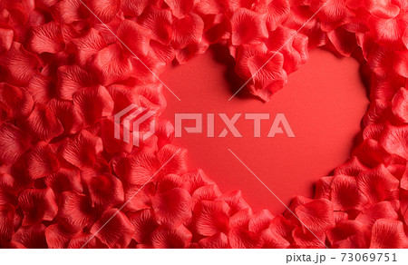 Love and Valentine's day concept. Red hearts made from rose petals on red paper background. Flat lay top view. 73069751