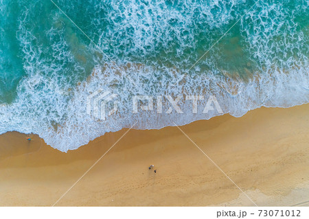 Amazing view aerial view drone camera photo of waves crashing on sandy shore,top view of beautiful sandy beach in the morning sunrise 73071012