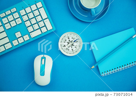 Work from home concept Business objects of coffee cup,compass,keyboard,mouse and paper note with pencil on blue paper table background 73071014