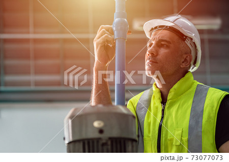 Professional engineer service team working maintenance and repair water pipe in factory 73077073