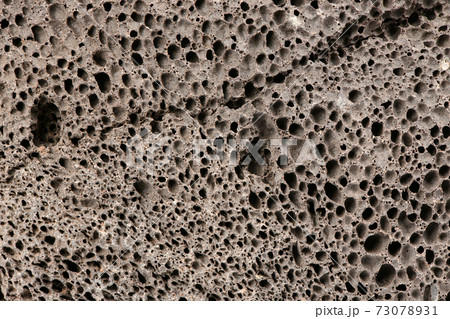 Surface of brown pumice - closeup. Pumice brown sponge texture for body wash. Surface of brown pumice - closeup. Pumice brown sponge texture for body wash. 73078931