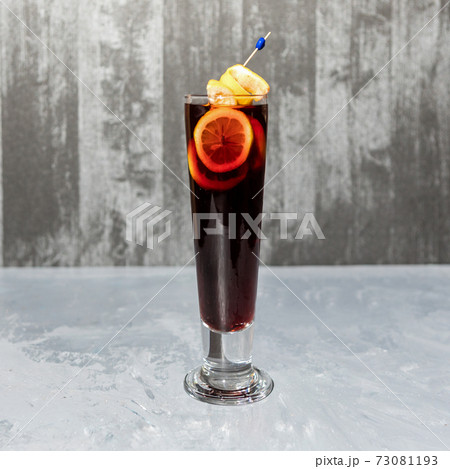 Glass of lemon cocktail isolated on a gray background 73081193