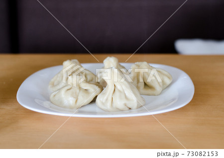 khinkali cooked on a ceramic plate 73082153