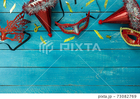 Table top view aerial image of beautiful colorful carnival festival background.Flat lay accessory object the several mask & decor confetti on modern blue wooden at home office desk studio.copy space. 73082769