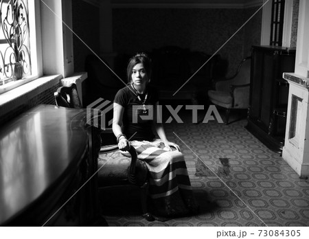 bright near the window, Beautiful chinese girl in the traditional heritage , oriental scenes and old classic mansion room in kaiping old town in guang 73084305