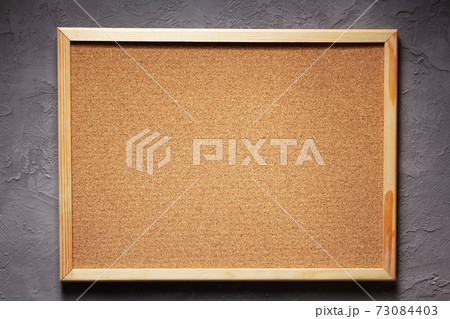 cork board or corkboard at grey concrete wall 73084403