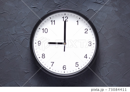 wall clock at dark grey painted background wall clock at dark grey painted background 73084411