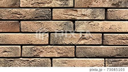 Old orange vintage wall made of craft stones Old orange vintage wall made of craft stones 73085103