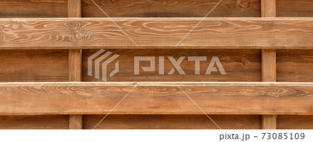 wall made of wooden logs background. wooden beams fence texture 73085109