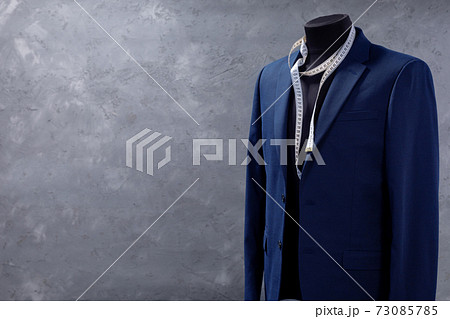 suit jacket on male tailor mannequin and sewing tools 73085785