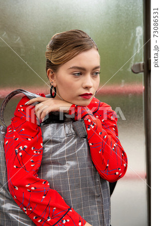 Young woman with blonde hair with window behind 73086531