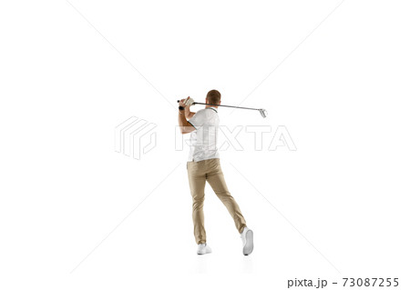 Golf player in a white shirt taking a swing isolated on white studio background Golf player in a white shirt taking a swing isolated on white studio background 73087255