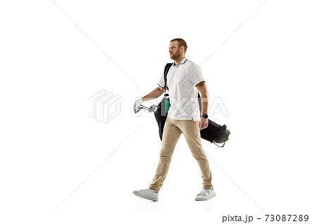 Golf player in a white shirt practicing, playing isolated on white studio background Golf player in a white shirt practicing, playing isolated on white studio background 73087289