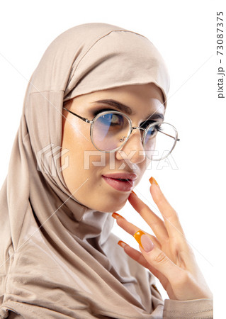 Beautiful arab woman posing in stylish hijab isolated on studio background. Fashion concept 73087375