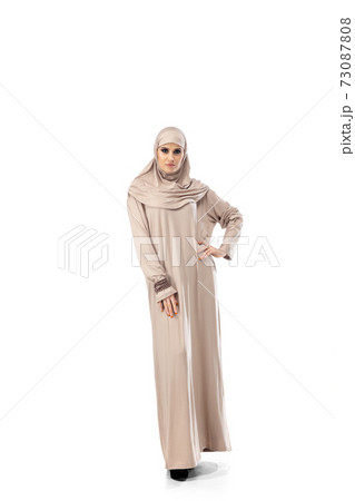 Beautiful arab woman posing in stylish hijab isolated on studio background. Fashion concept Beautiful arab woman posing in stylish hijab isolated on studio background. Fashion concept 73087808