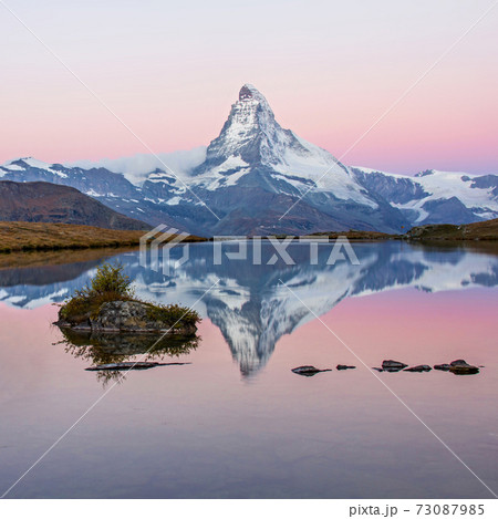 Matterhorn mountain before sunrise with reflection in the Riffelsee lake - Zermatt in Switzerland 73087985