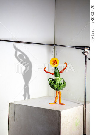 Flying food composition making beautiful ballerina drawing shadow on the wall 73088220