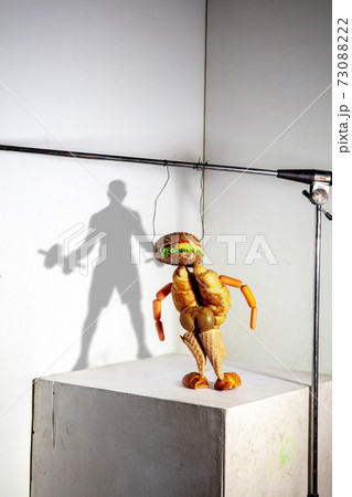 Flying food composition making beautiful sportsman drawing shadow on the wall Flying food composition making beautiful sportsman drawing shadow on the wall 73088222