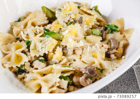 Farfalle pasta with champignon mushrooms asparagus and garlic creamy sauce Farfalle pasta with champignon mushrooms asparagus and garlic creamy sauce 73089257