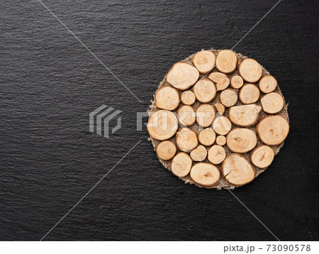 round wooden stand on black surface, top view round wooden stand on black surface, top view 73090578