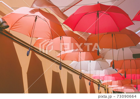 Beautiful hanging umbrellas, sweet pink for love concept. 73090664