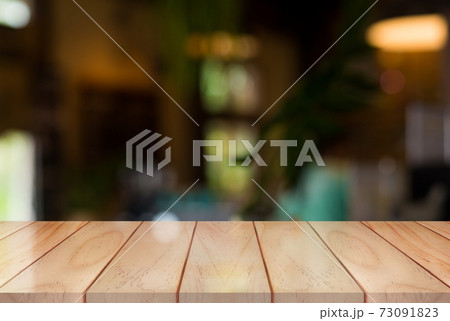 Empty wooden table top with lights bokeh on blur restaurant background Empty wooden table top with lights bokeh on blur restaurant background 73091823