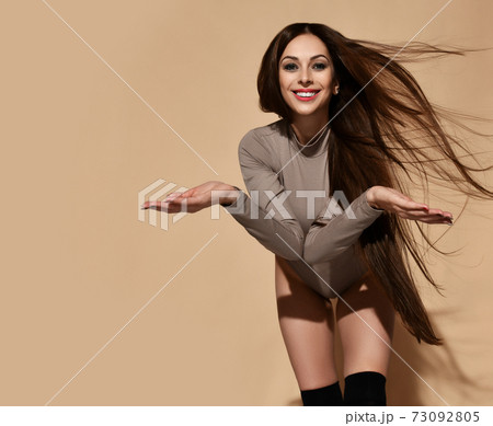 Cheerful young woman with long straight fluttering Cheerful young woman with long straight fluttering 73092805
