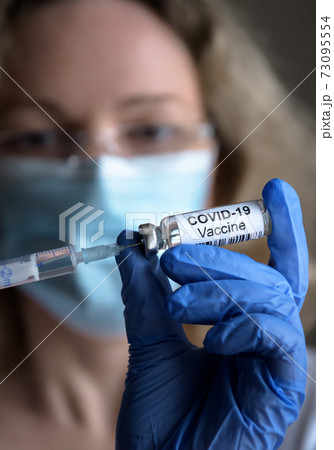 COVID-19 vaccine in doctor`s hand closeup COVID-19 vaccine in doctor`s hand closeup 73095554