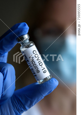 COVID-19 vaccine in doctor`s hand close-up COVID-19 vaccine in doctor`s hand close-up 73095555