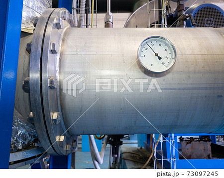 Measuring dial gauge. The measuring device against silver pipeline 73097245