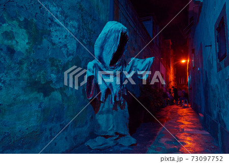 Silhouette of scary mythical ghost against wall with duotone lights Silhouette of scary mythical ghost against wall with duotone lights 73097752