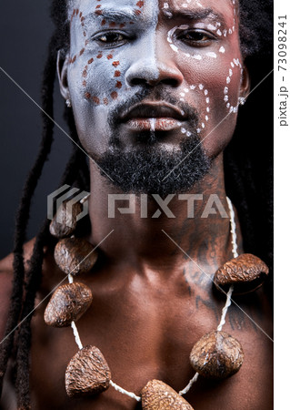 handsome afro american guy with authentic chain on neck look at camera handsome afro american guy with authentic chain on neck look at camera 73098241