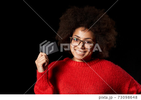 Discontent serious young African-American girl in glasses and red shirt 73098648