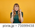Crosses fingers, prays before important occasion, wishes luck, hopes in victory 73099438