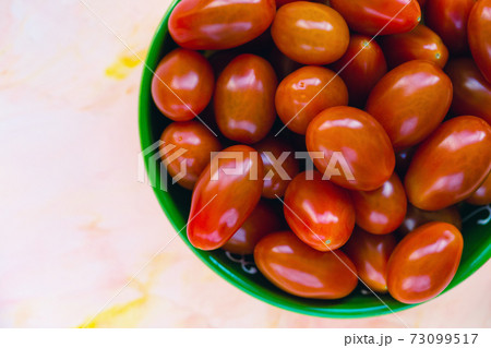 Fresh red cherry tomatoes on light background Fresh red cherry tomatoes on light background 73099517