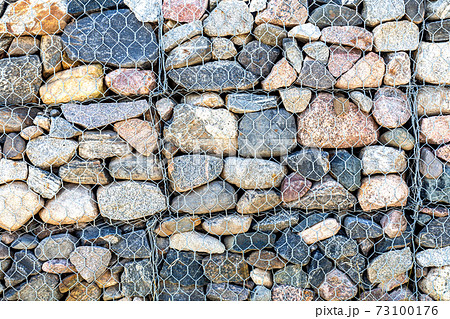 Stone wall with metal grid as background 73100176