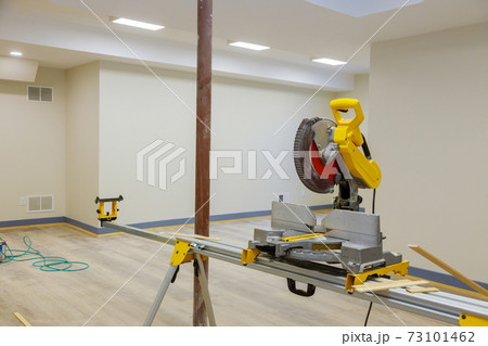 Construction remodeling home with circular saw cutting wood trim molding Construction remodeling home with circular saw cutting wood trim molding 73101462