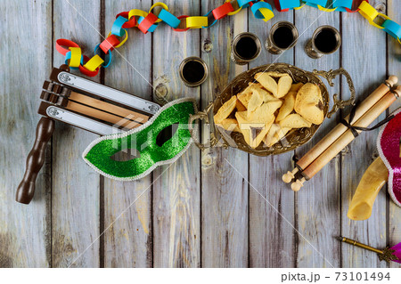 Carnival with noisemaker Hamantaschen cookies Purim jewish holiday 73101494