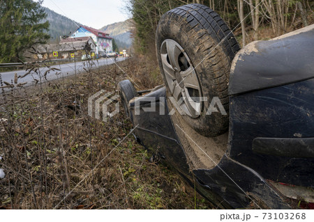 The Car Got Into an Accident on the Mountain Road and fell Upside Down. The Blue Car Turned over in a Ditch near the Highway The Car Got Into an Accident on the Mountain Road and fell Upside Down. The Blue Car Turned over in a Ditch near the Highway 73103268