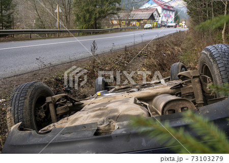 The Car Got Into an Accident on the Mountain Road and fell Upside Down. The Blue Car Turned over in a Ditch near the Highway The Car Got Into an Accident on the Mountain Road and fell Upside Down. The Blue Car Turned over in a Ditch near the Highway 73103279