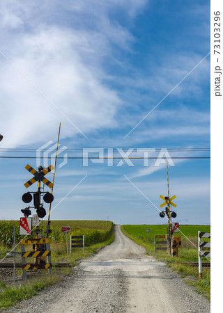 北海道の素敵な畑と踏切のある風景の写真素材