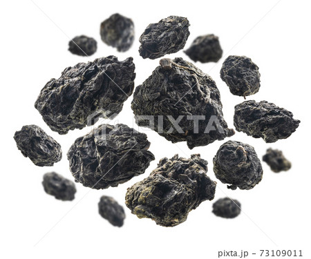 Green oolong tea levitates on white background 73109011