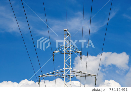 High voltage transmission lines against the blue sky. 73112491