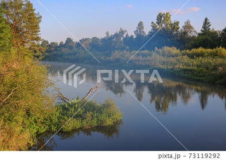 A winding shallow river on a clear summer day. A winding shallow river on a clear summer day. 73119292