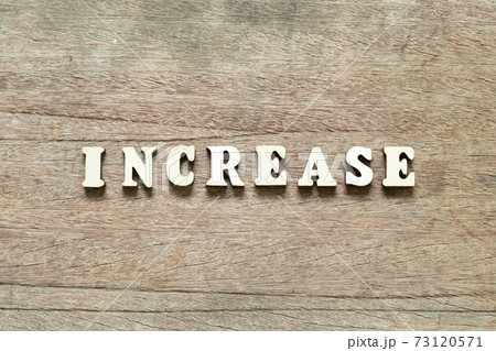 Alphabet letter block in word increase on wood background Alphabet letter block in word increase on wood background 73120571