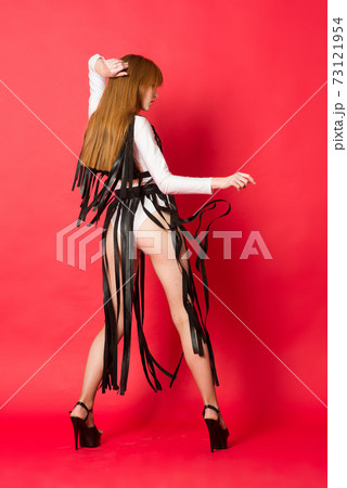 Young beautiful dancer posing in studio on red background Young beautiful dancer posing in studio on red background 73121954