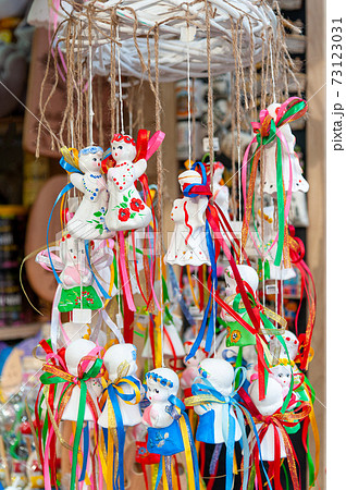 Decorative toys with city symbols being sold on Lviv Christmas Market in front of the Lviv Opera House..Christmas fair in Lviv, Ukraine 2021. 73123031