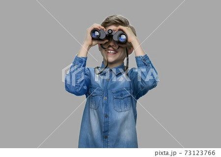 Little boy looking through binoculars. 73123766